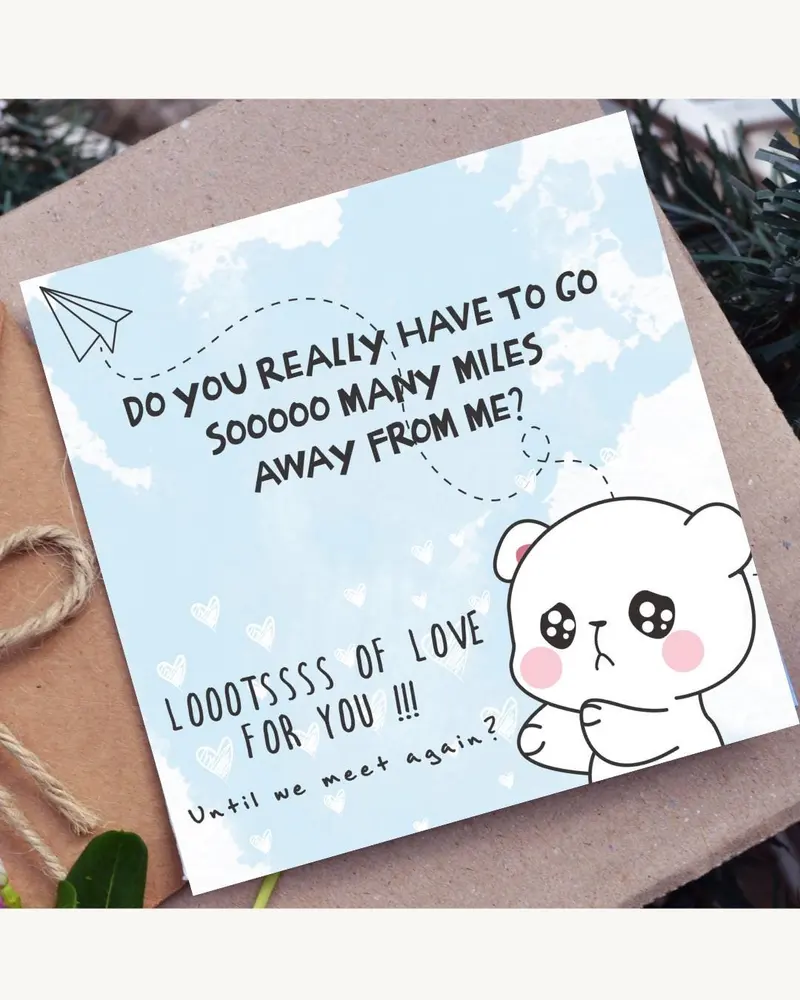 A greeting card with a light blue background and a cartoon bear illustration. The card has text that