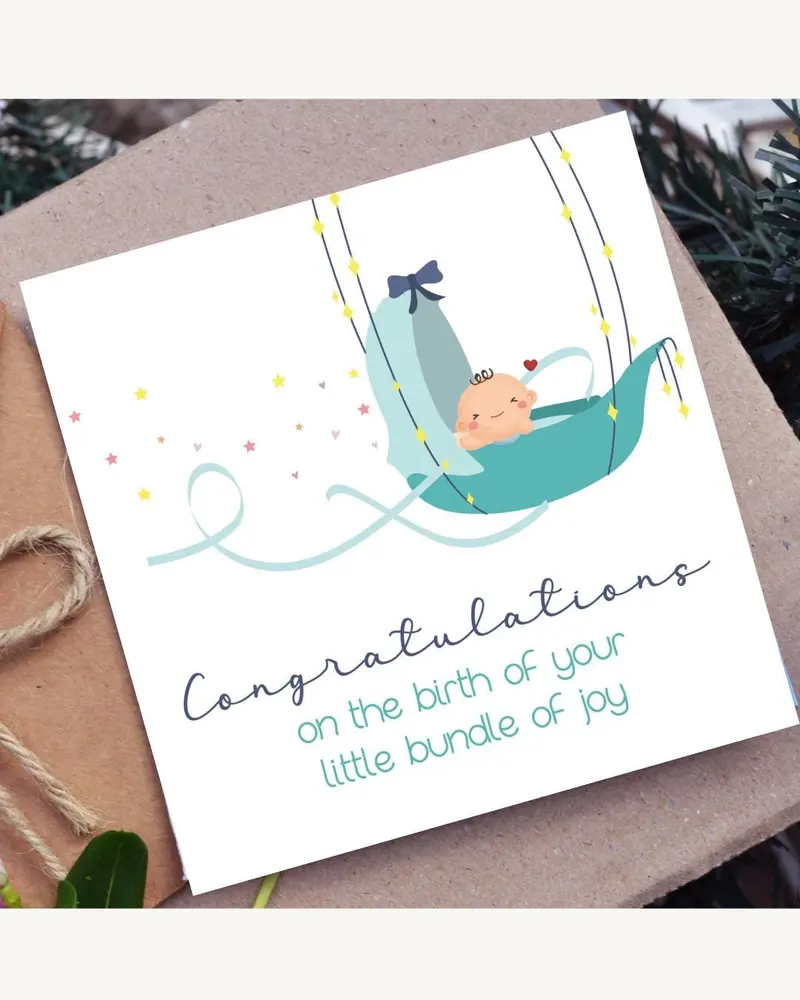 A baby shower card with a teal baby carriage illustration. The card has the text "Congratulations on
