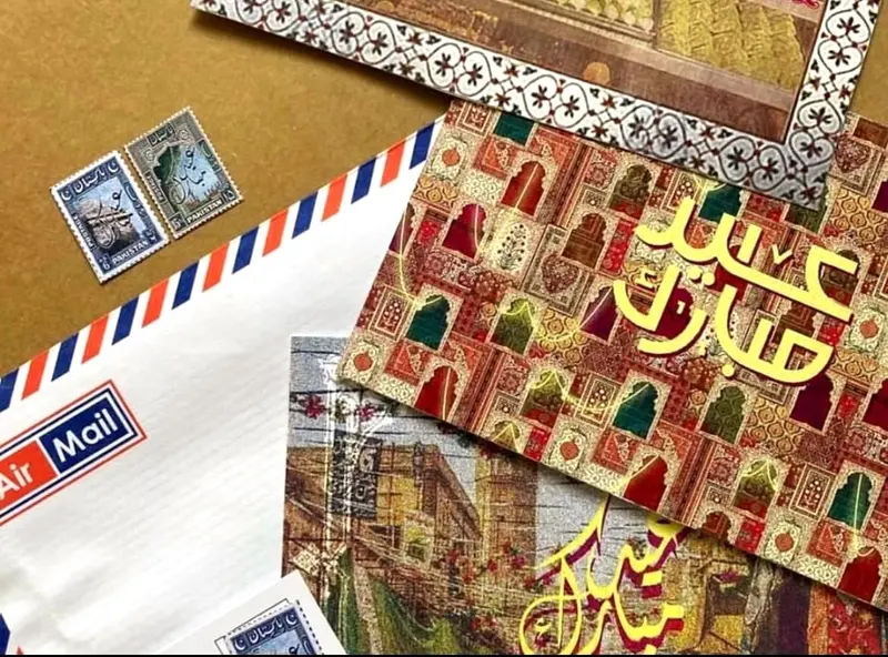 A collection of stationery featuring a white Air Mail envelope with red and blue stripes, postage st