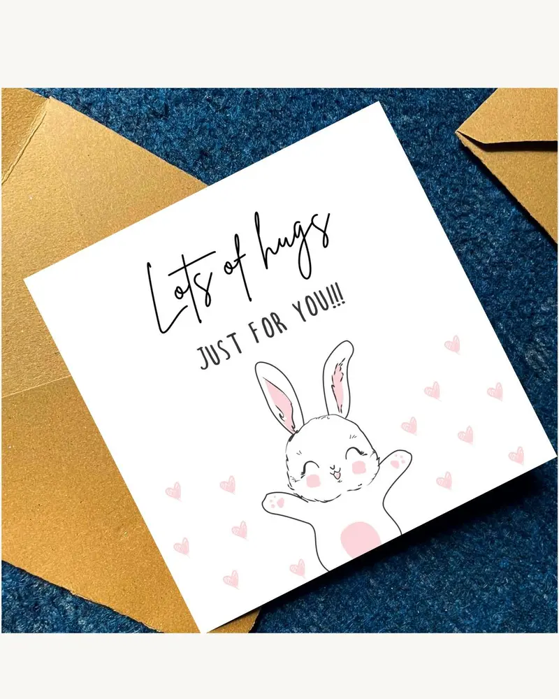 A white card with the words "Lots of hugs JUST FOR YOU!!!" and a cartoon bunny with pink accents and