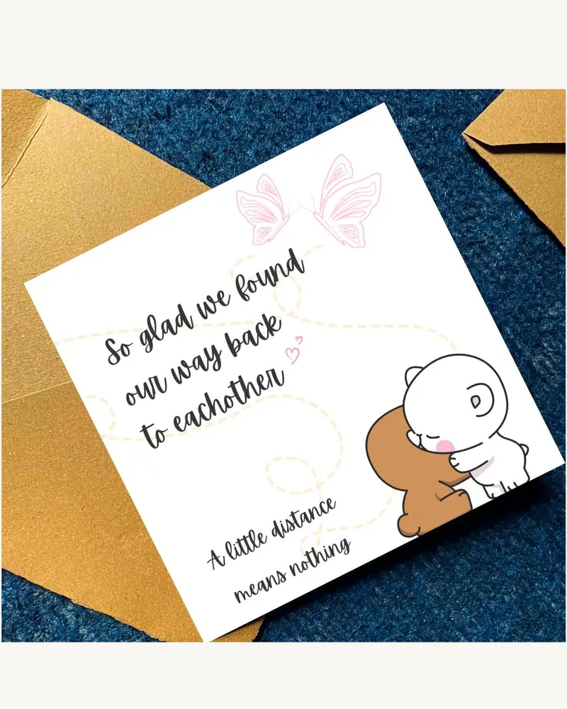A white greeting card with the text "So glad we found our way back to each other" and "A little dist