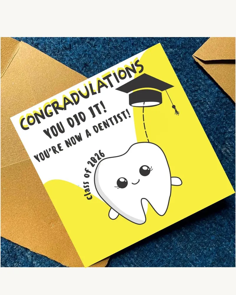 A graduation card with the text "CONGRATULATIONS YOU DID IT! YOU'RE NOW A DENTIST!" features a carto