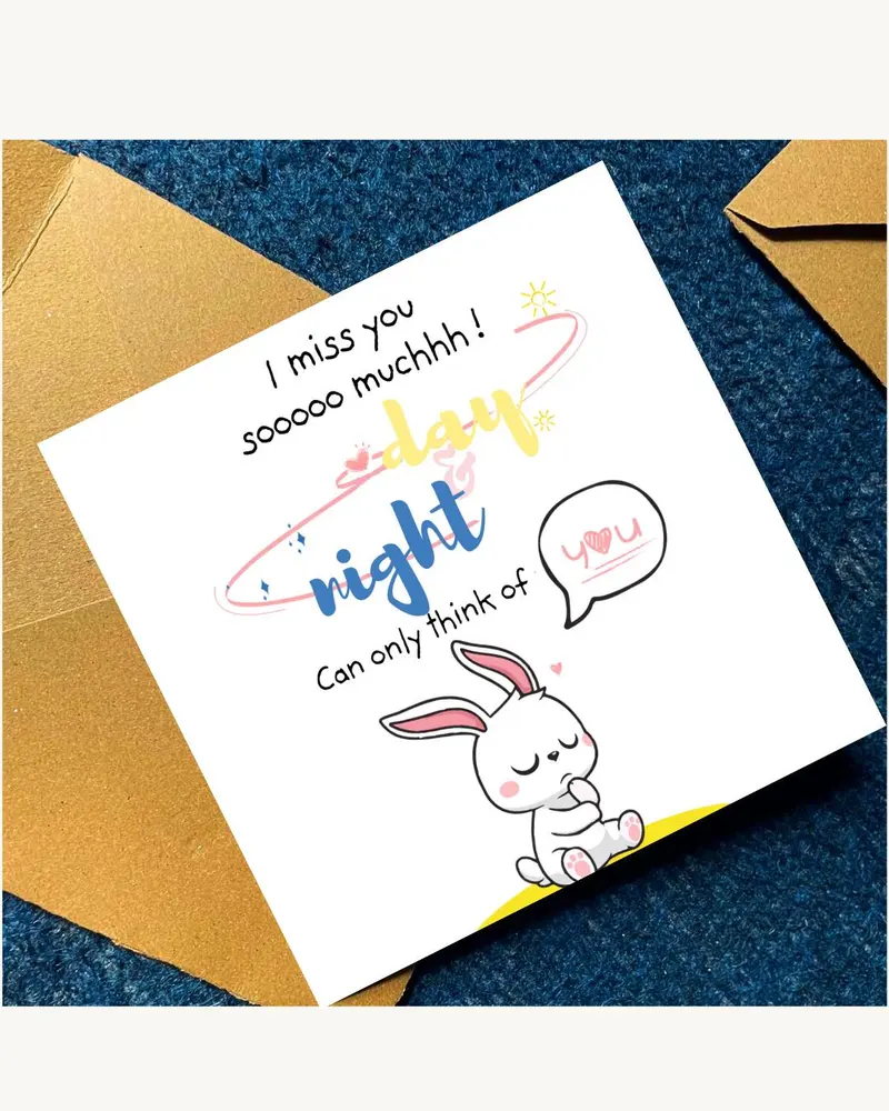A square greeting card featuring a cartoon white rabbit with pink ears and paws. The text reads: I m