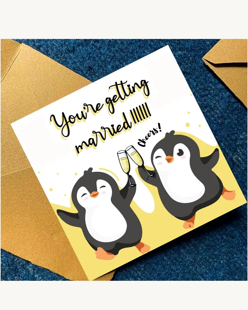 A square greeting card featuring two cartoon penguins on a yellow background. The penguins are holdi